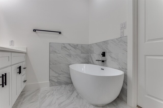 bathroom with vanity and a washtub