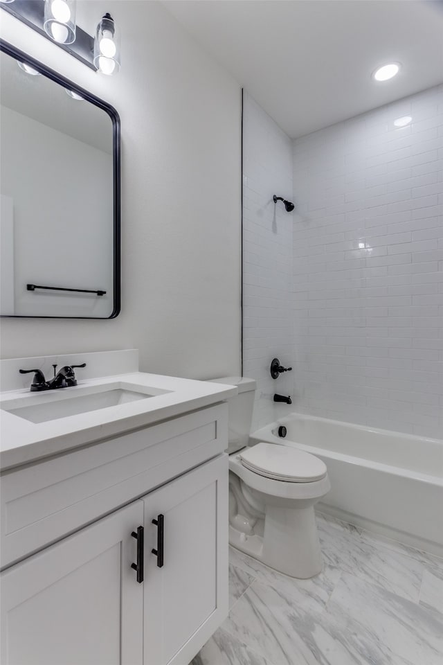 full bathroom with toilet, tiled shower / bath combo, and vanity