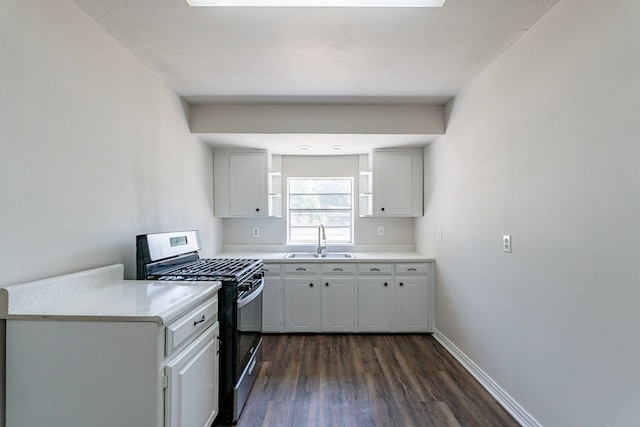 kitchen with white cabinetry, dark wood-type flooring, stainless steel range with gas stovetop, and sink