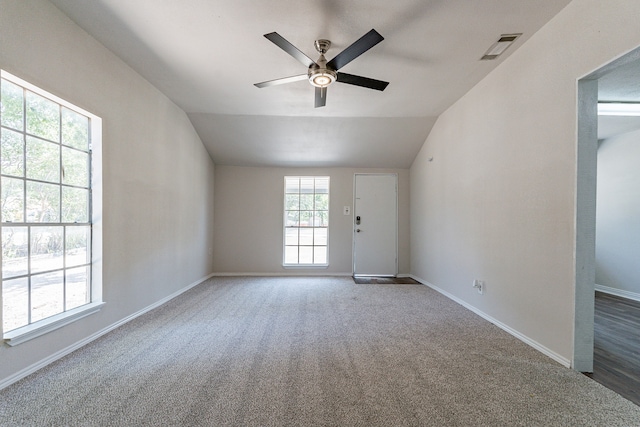 unfurnished room with ceiling fan, carpet floors, and vaulted ceiling