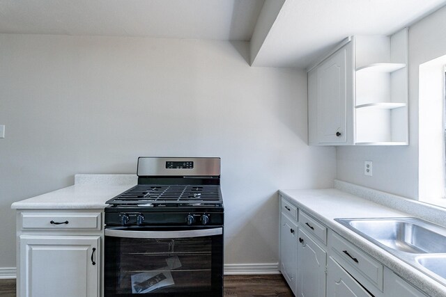 kitchen featuring dark hardwood / wood-style flooring, sink, and white cabinets