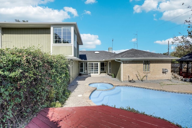 view of pool featuring a wooden deck and an in ground hot tub