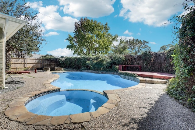 view of pool with an in ground hot tub