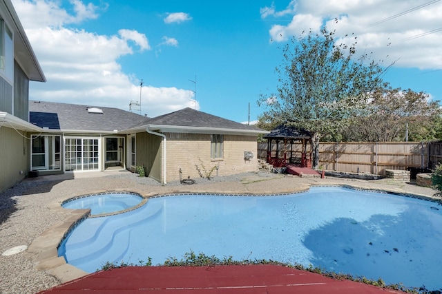 view of pool featuring a gazebo, a patio area, and an in ground hot tub