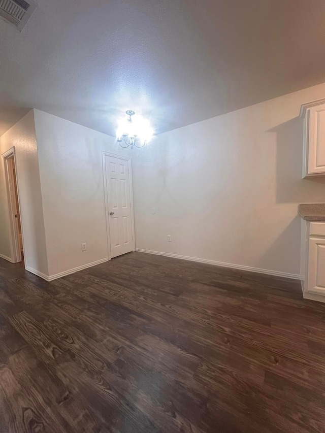 spare room featuring dark wood-type flooring