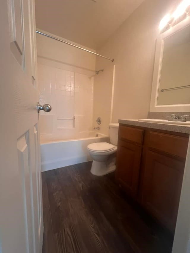 full bathroom with toilet, hardwood / wood-style flooring, shower / bathing tub combination, and vanity