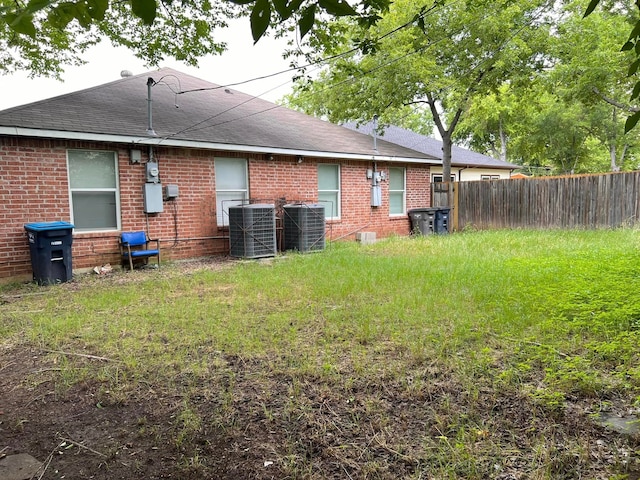 rear view of house featuring central AC