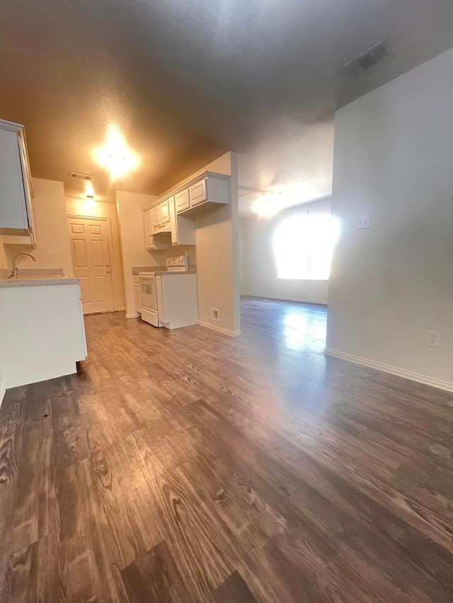 unfurnished living room featuring dark hardwood / wood-style flooring