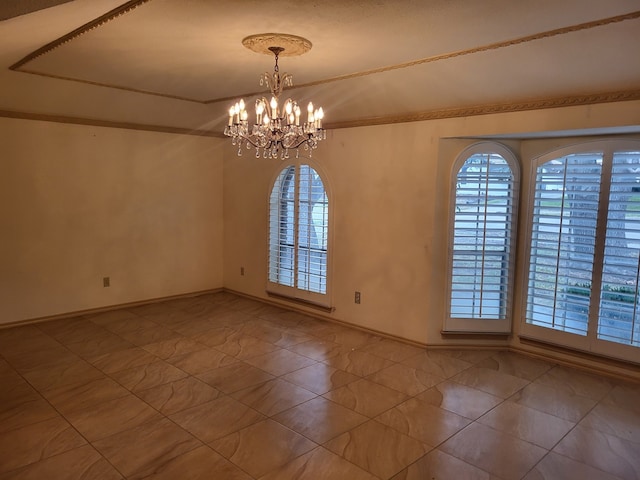 empty room featuring a notable chandelier, ornamental molding, and tile patterned floors