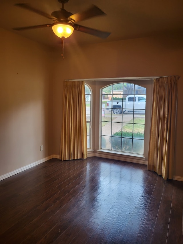 spare room with ceiling fan and dark hardwood / wood-style floors