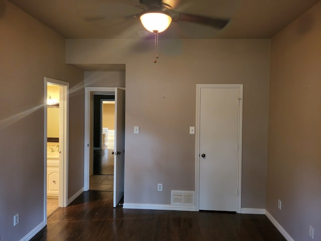 unfurnished room with ceiling fan and dark hardwood / wood-style flooring