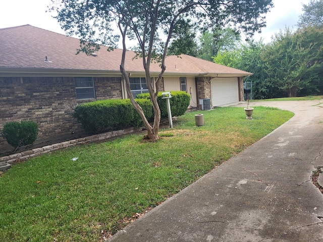 single story home with central AC unit, a garage, and a front lawn