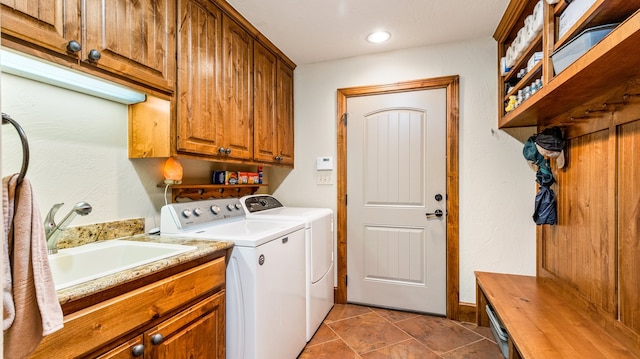 laundry room with sink, cabinets, and washer and dryer