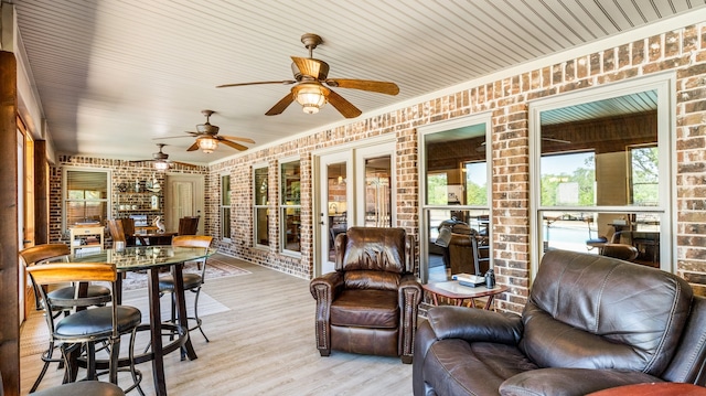 sunroom featuring ceiling fan