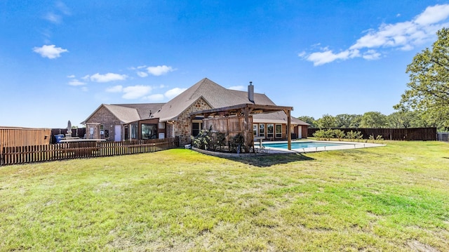 back of house with a fenced in pool, a yard, and a patio area