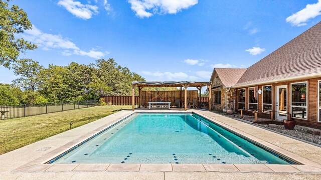 view of swimming pool featuring a lawn and a patio