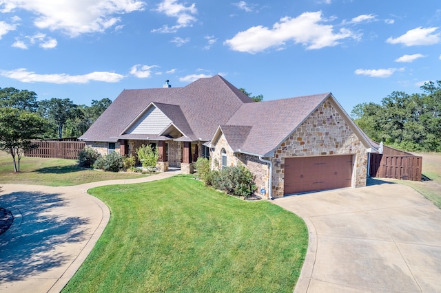 view of front of house with a garage and a front lawn