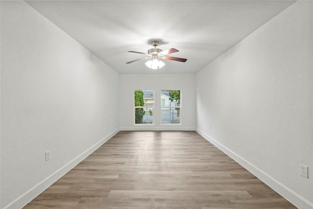 empty room featuring light wood-type flooring and ceiling fan