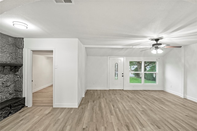 unfurnished living room featuring a textured ceiling, ceiling fan, and light hardwood / wood-style floors