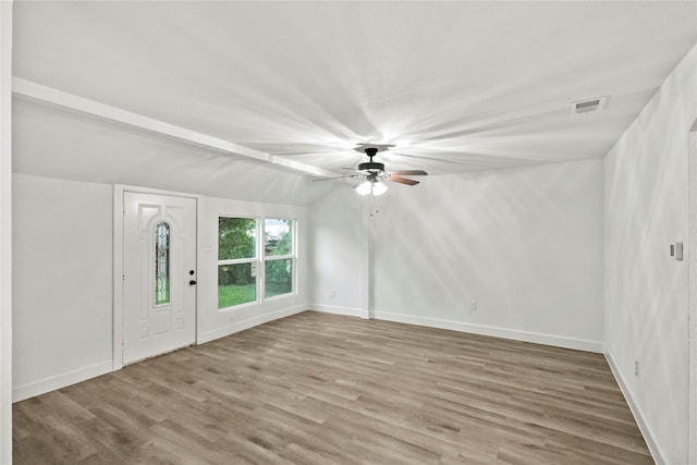 entrance foyer with ceiling fan, lofted ceiling with beams, and light hardwood / wood-style floors