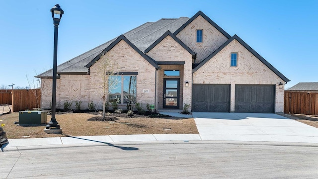 view of front facade with fence, concrete driveway, a shingled roof, a garage, and brick siding