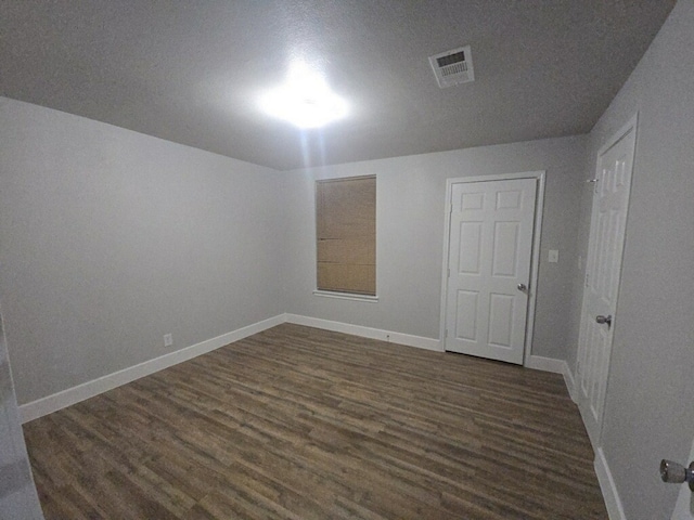 unfurnished room with dark hardwood / wood-style floors