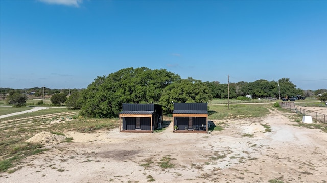 exterior space with a rural view and an outdoor structure