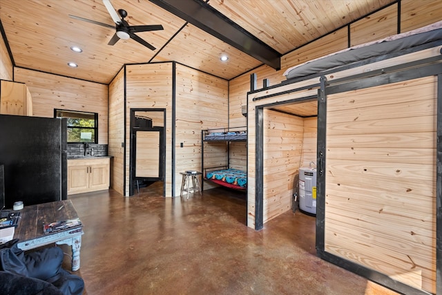 interior space featuring a barn door, wooden walls, and wooden ceiling