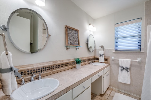 bathroom featuring vanity, tile patterned flooring, and tile walls