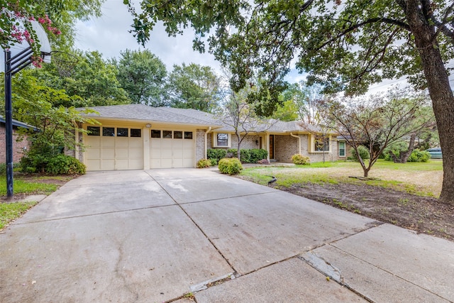 ranch-style house with a garage and a front lawn