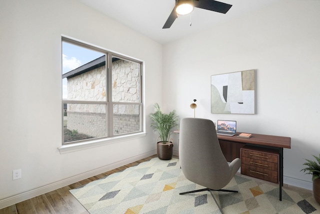 office area featuring wood finished floors, a ceiling fan, and baseboards