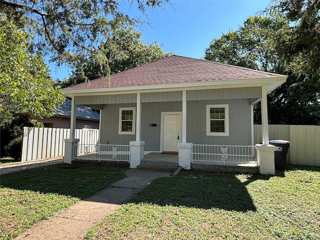 view of front of home featuring covered porch and a front yard