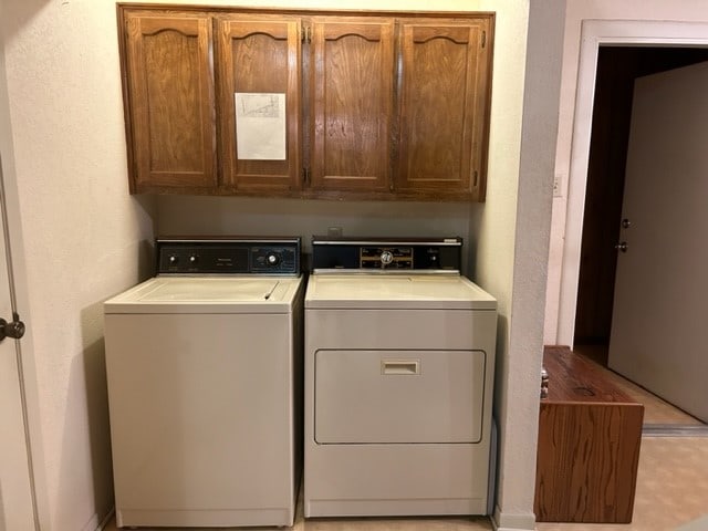 washroom featuring cabinets and independent washer and dryer