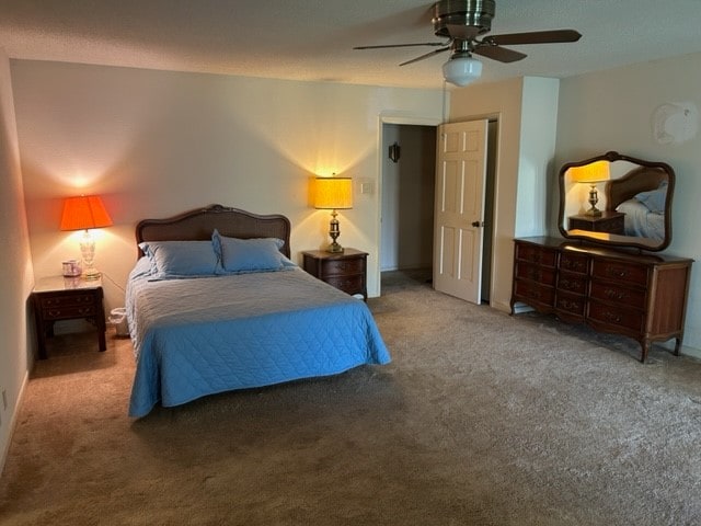 carpeted bedroom with ceiling fan