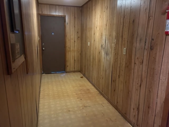 hallway with wood walls