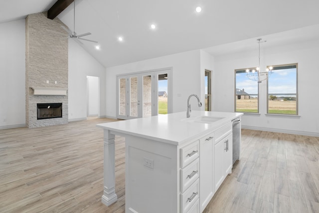 kitchen featuring light wood finished floors, open floor plan, and a sink