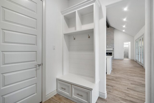 mudroom featuring lofted ceiling, light wood-type flooring, baseboards, and recessed lighting