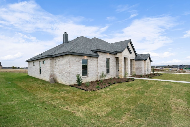 view of side of home with a yard