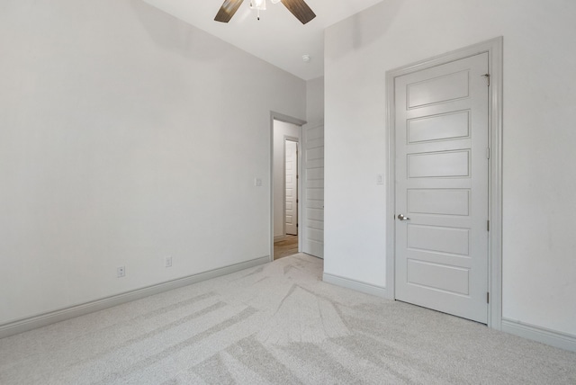 unfurnished bedroom featuring a ceiling fan, carpet flooring, and baseboards