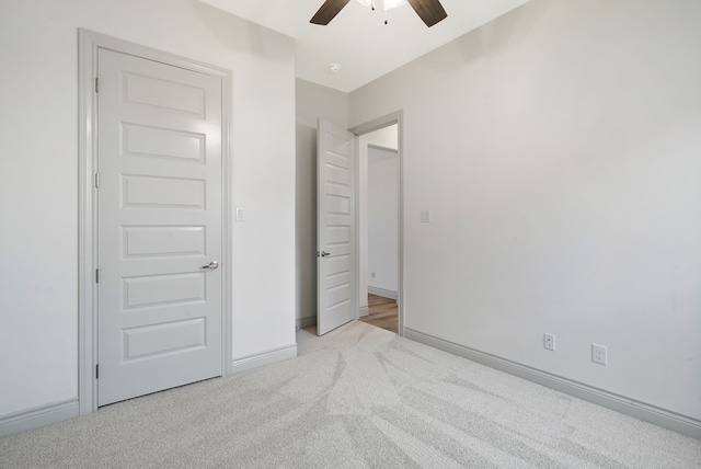 unfurnished bedroom with a ceiling fan, baseboards, and carpet flooring