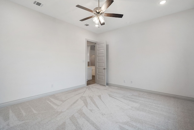 unfurnished bedroom with ceiling fan, recessed lighting, light colored carpet, visible vents, and baseboards