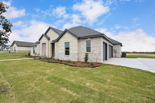 french country style house featuring an attached garage, driveway, a front lawn, and cooling unit