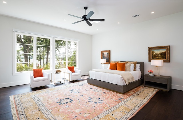 bedroom with dark hardwood / wood-style flooring and ceiling fan