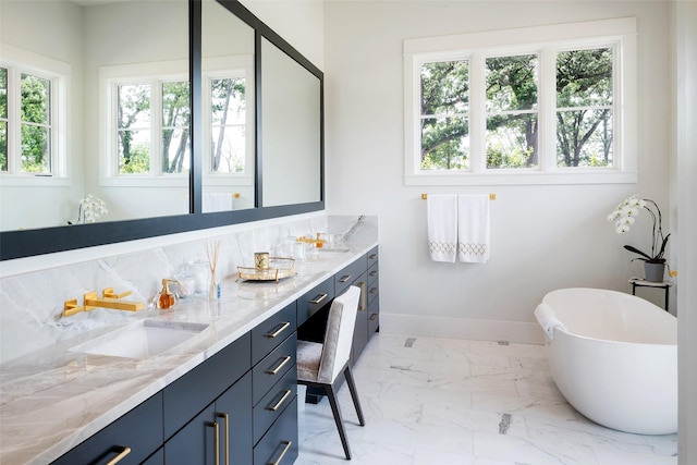 bathroom featuring vanity and a bath