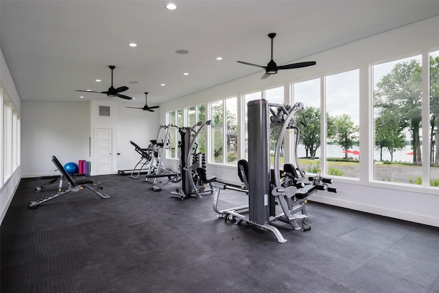 exercise room with ceiling fan and a wealth of natural light