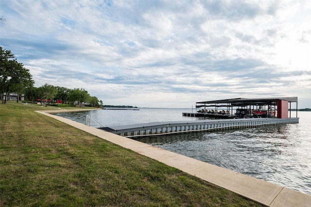 dock area with a water view and a lawn