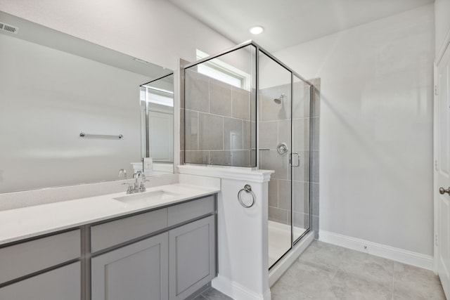 bathroom with vanity, tile patterned floors, and an enclosed shower