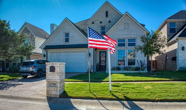 view of front of property with a garage and a front yard