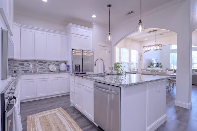 kitchen featuring dark wood-type flooring, a center island with sink, white cabinets, and stainless steel appliances