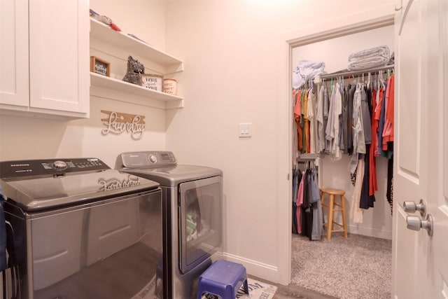 laundry room featuring separate washer and dryer, carpet, and cabinets